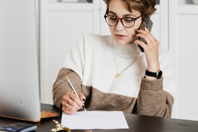 Talent Acquisition Specialist on the phone taking notes